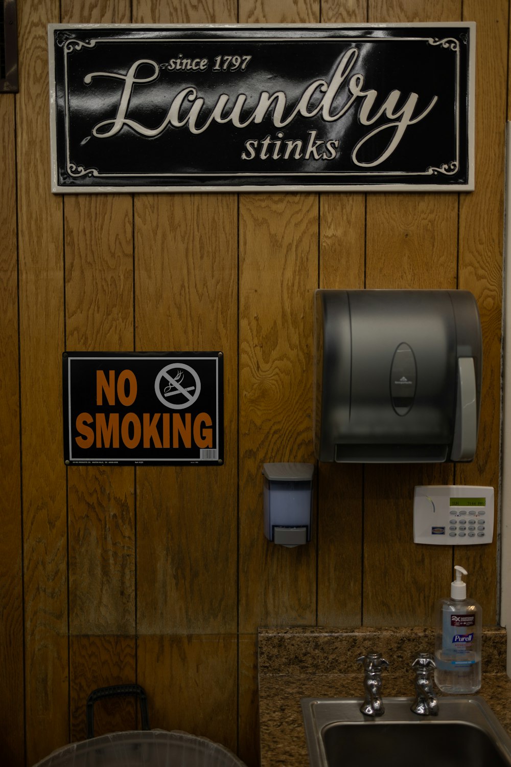 a bathroom with a no smoking sign on the wall