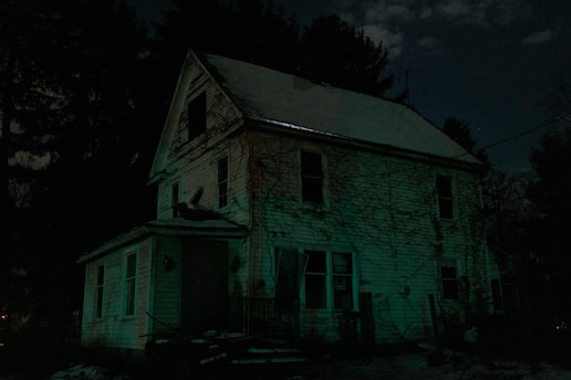 A spooky Halloween haunted house with eerie lighting.
