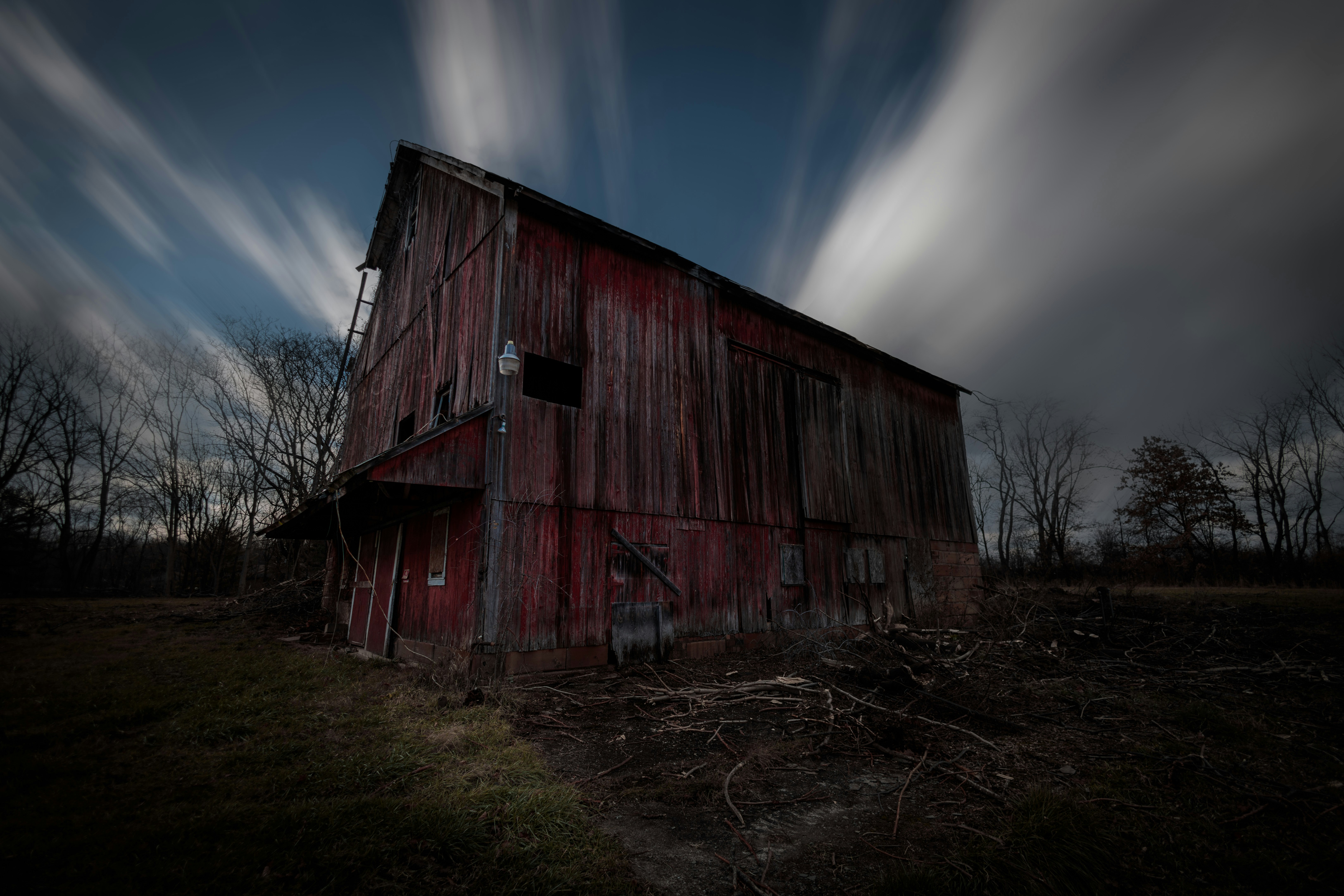 The clouds whip by an old abandoned barn.