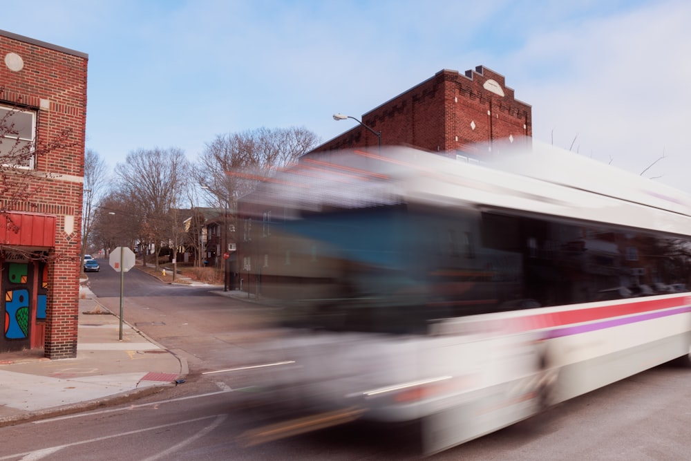 a blurry photo of a bus driving down a street