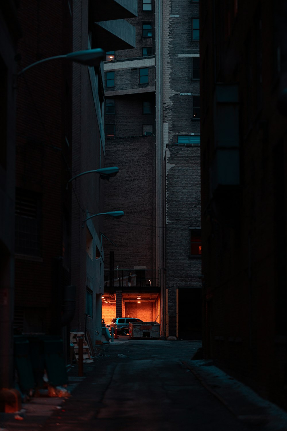 a dark alley way with a building in the background