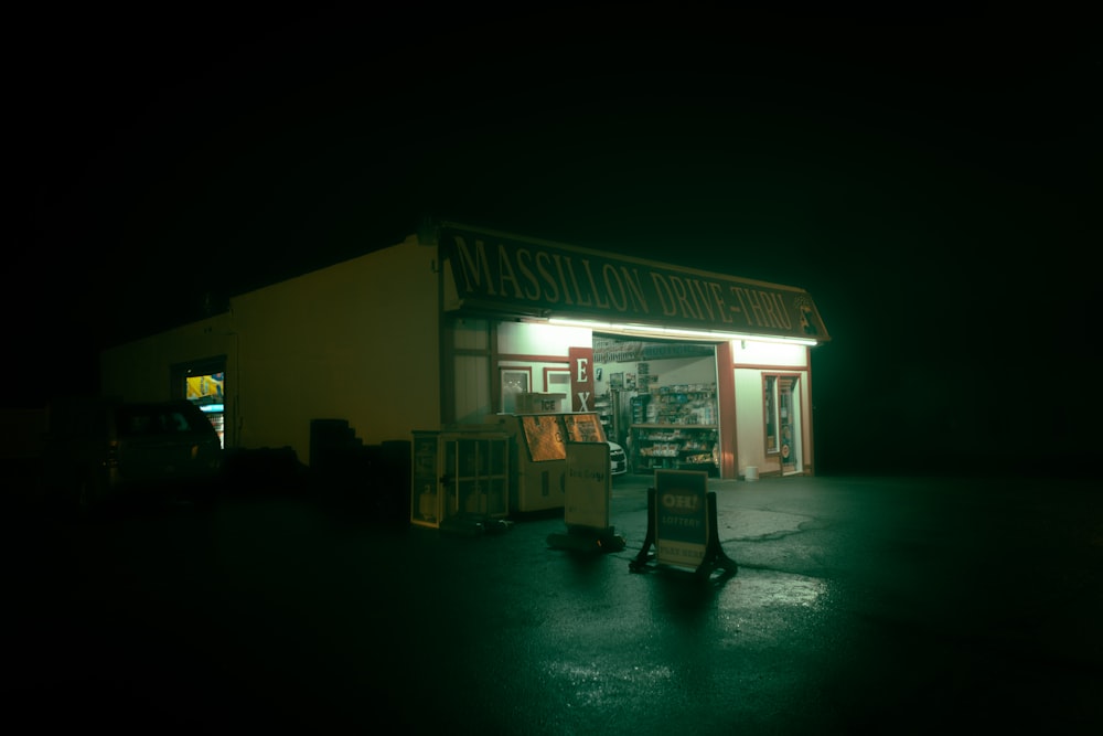 a gas station lit up at night in the dark