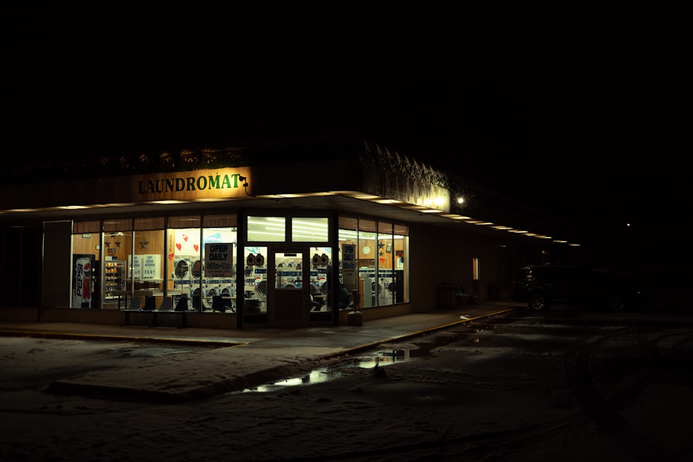 a store front at night with lights on