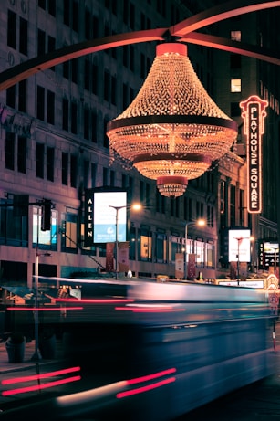 a bus driving down a street next to tall buildings