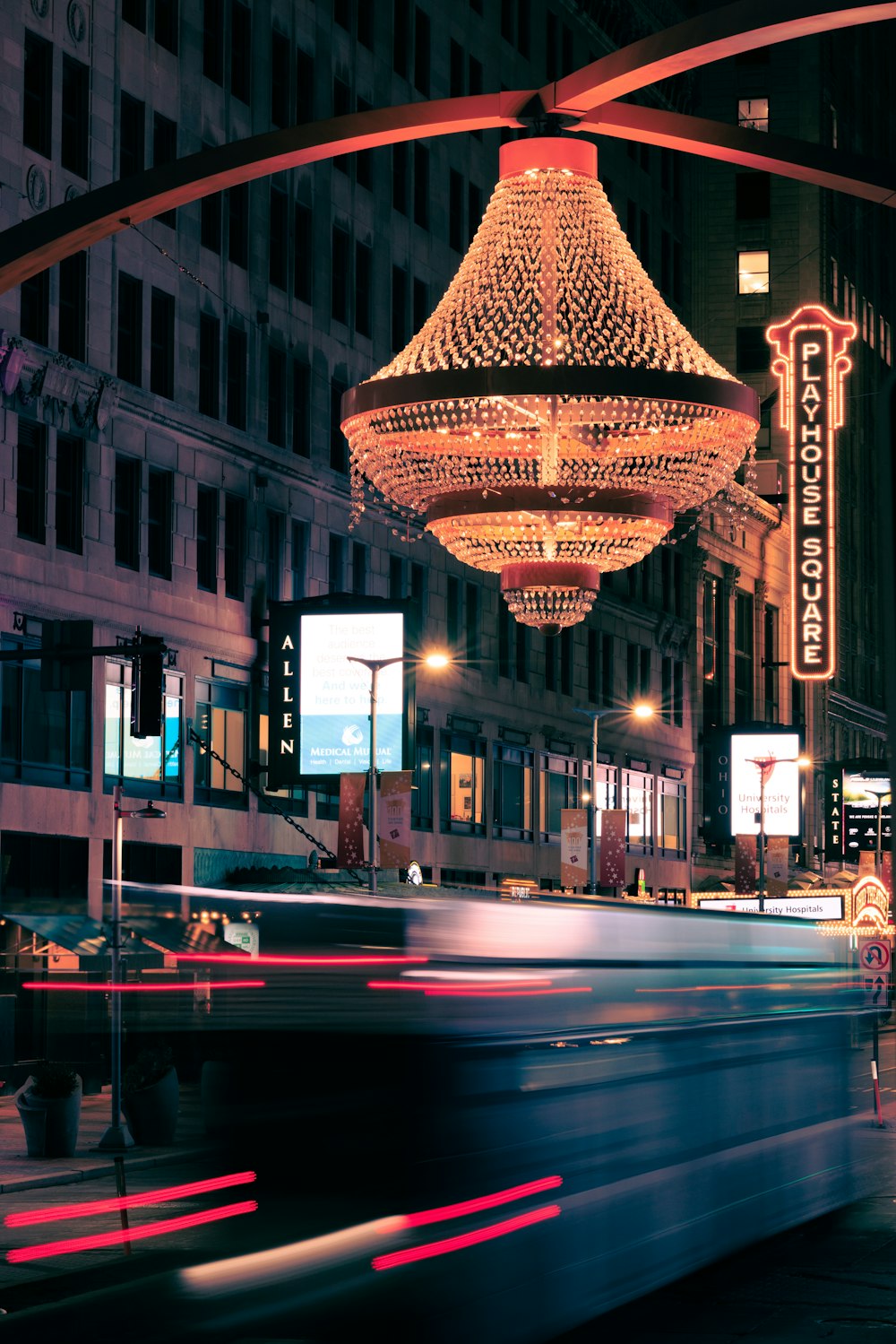 a bus driving down a street next to tall buildings