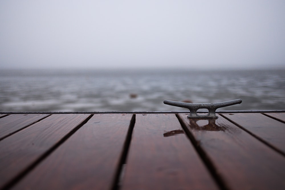 a pair of scissors sitting on top of a wooden table