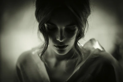 A striking black-and-white portrait of a woman caught in a moment of quiet reflection, showcasing Juan Martinez's keen eye for emotion.