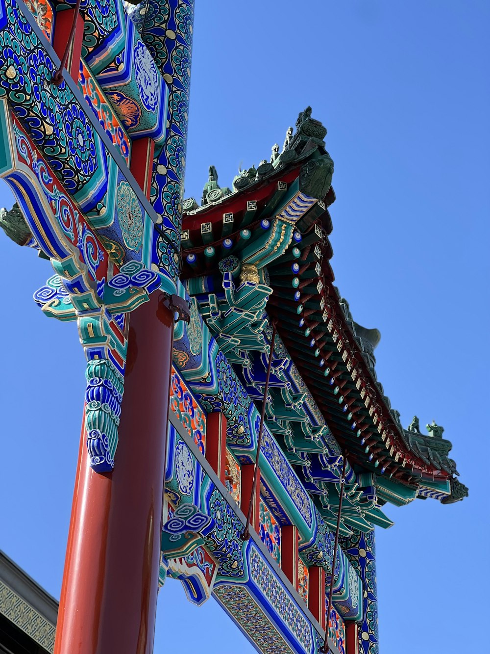 a tall red and blue building with a blue sky in the background