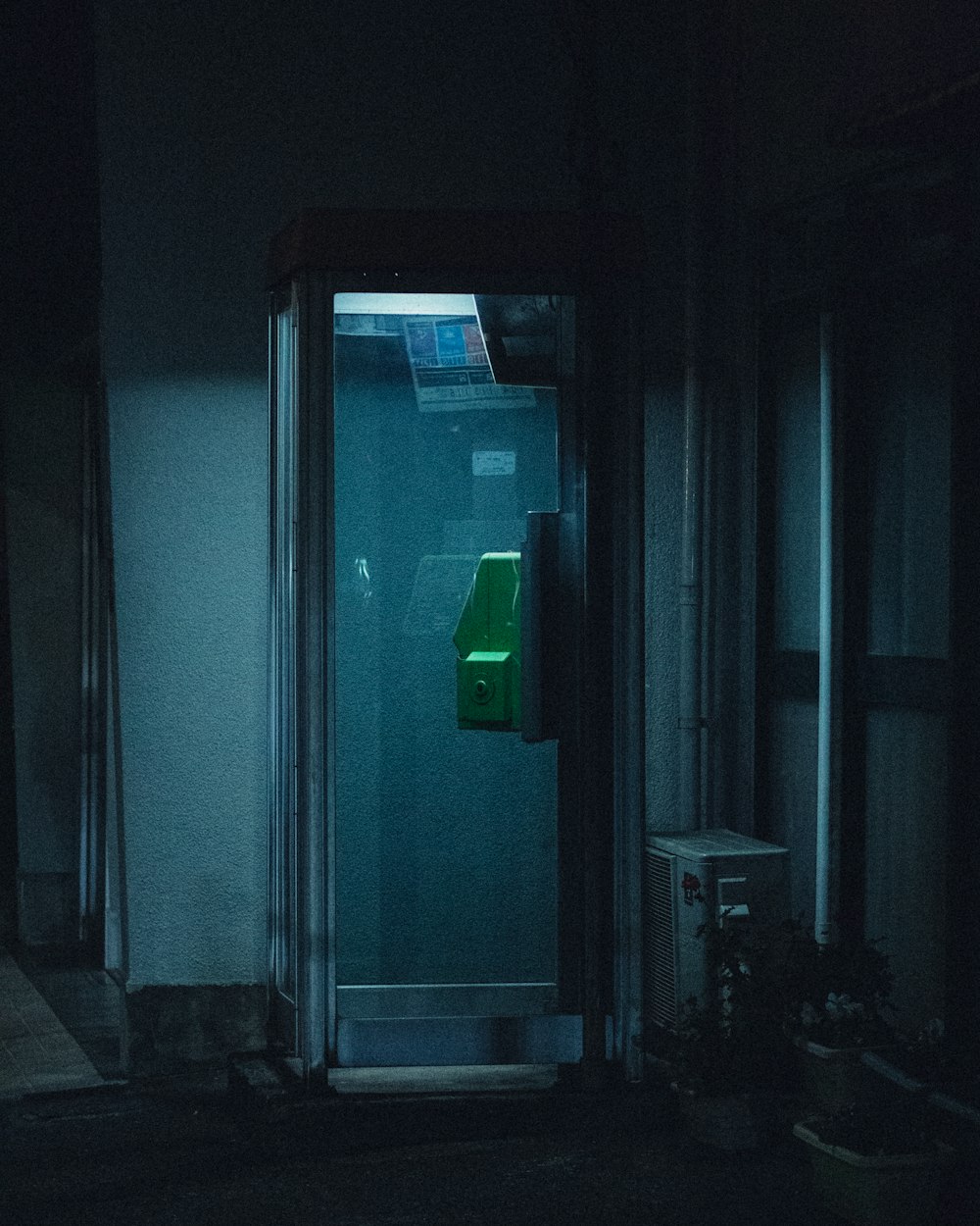a dark room with a green object in the corner