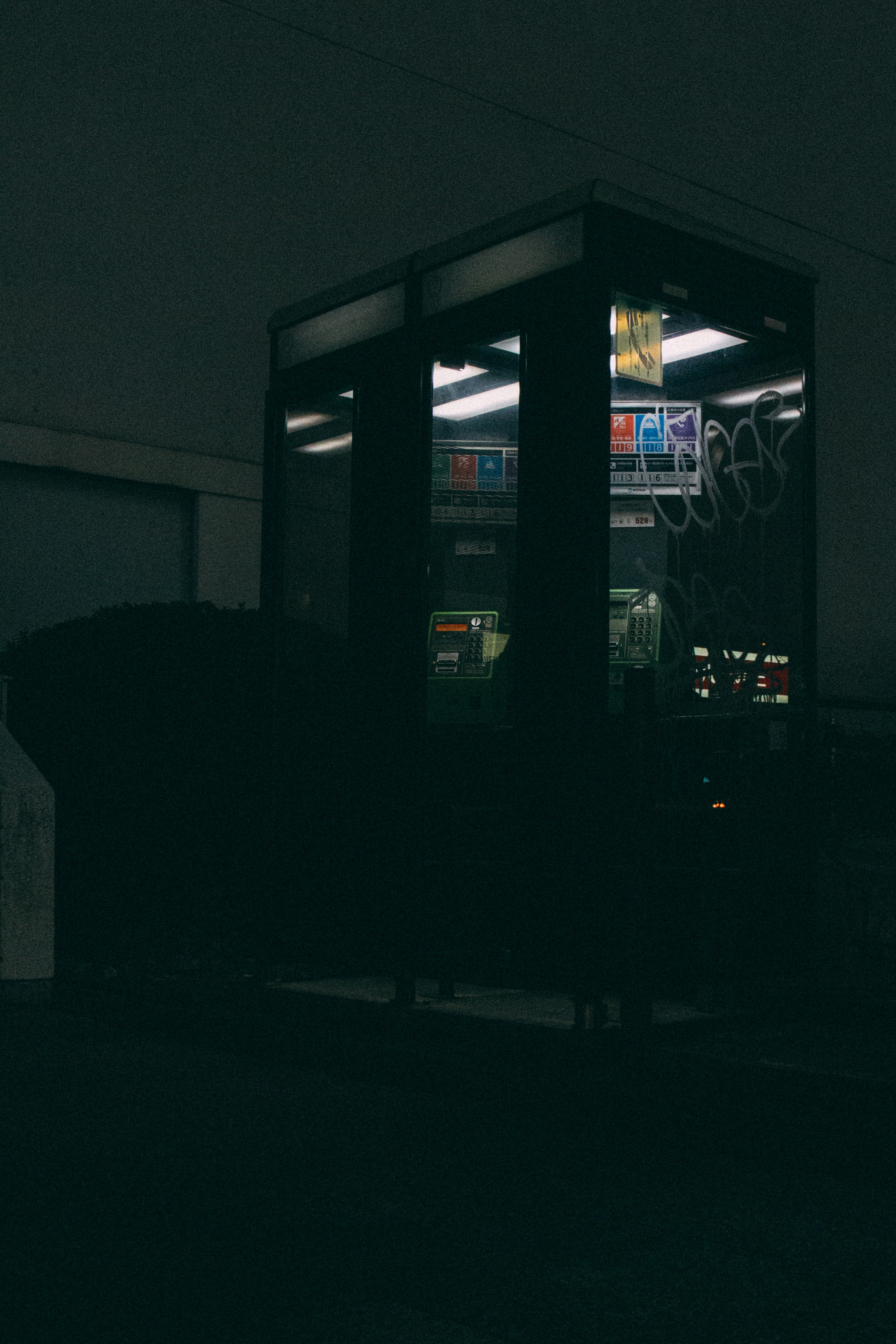 Telephone booths at midnight