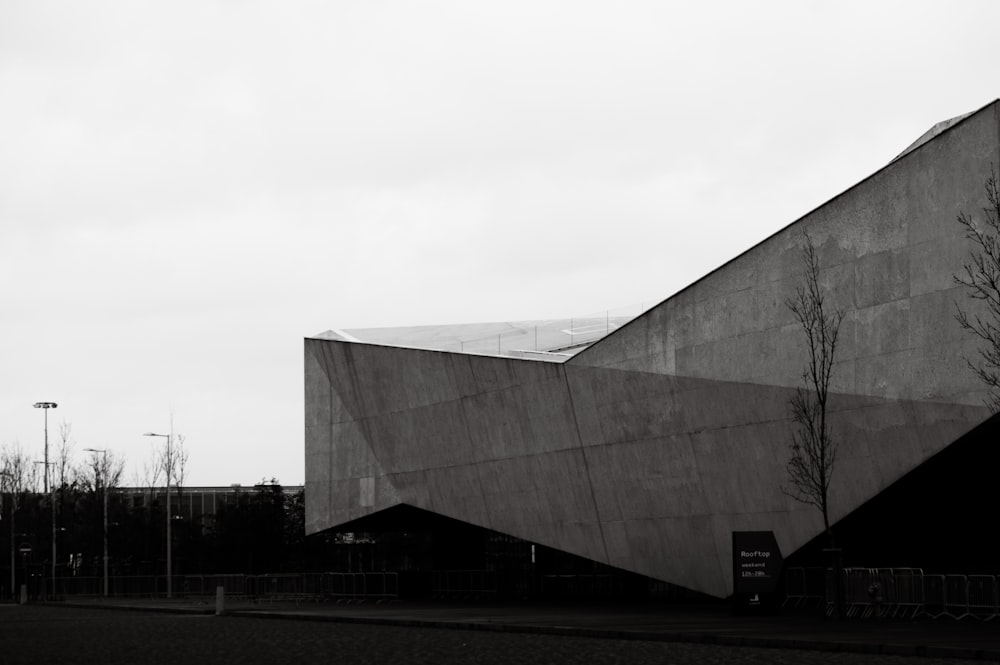 a black and white photo of a triangular building