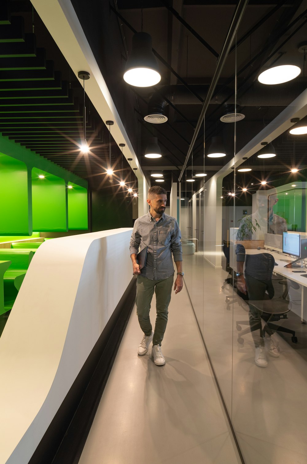 a man walking down a hallway in an office