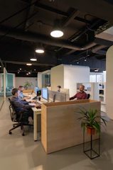a couple of men sitting at a desk in an office