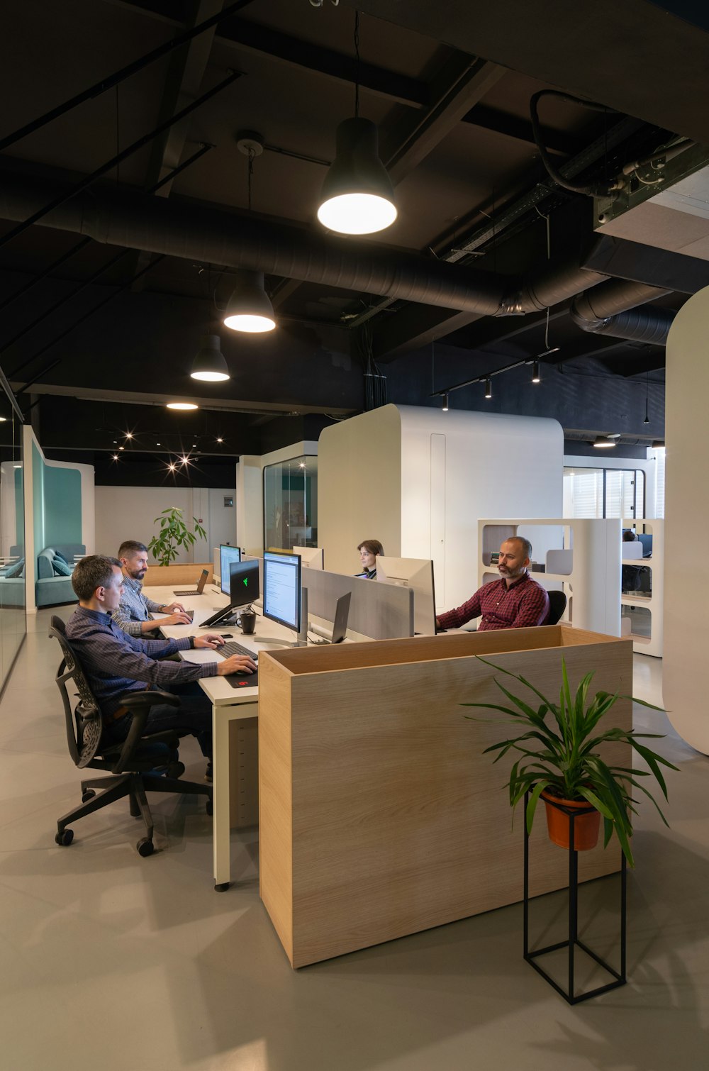 a couple of men sitting at a desk in an office