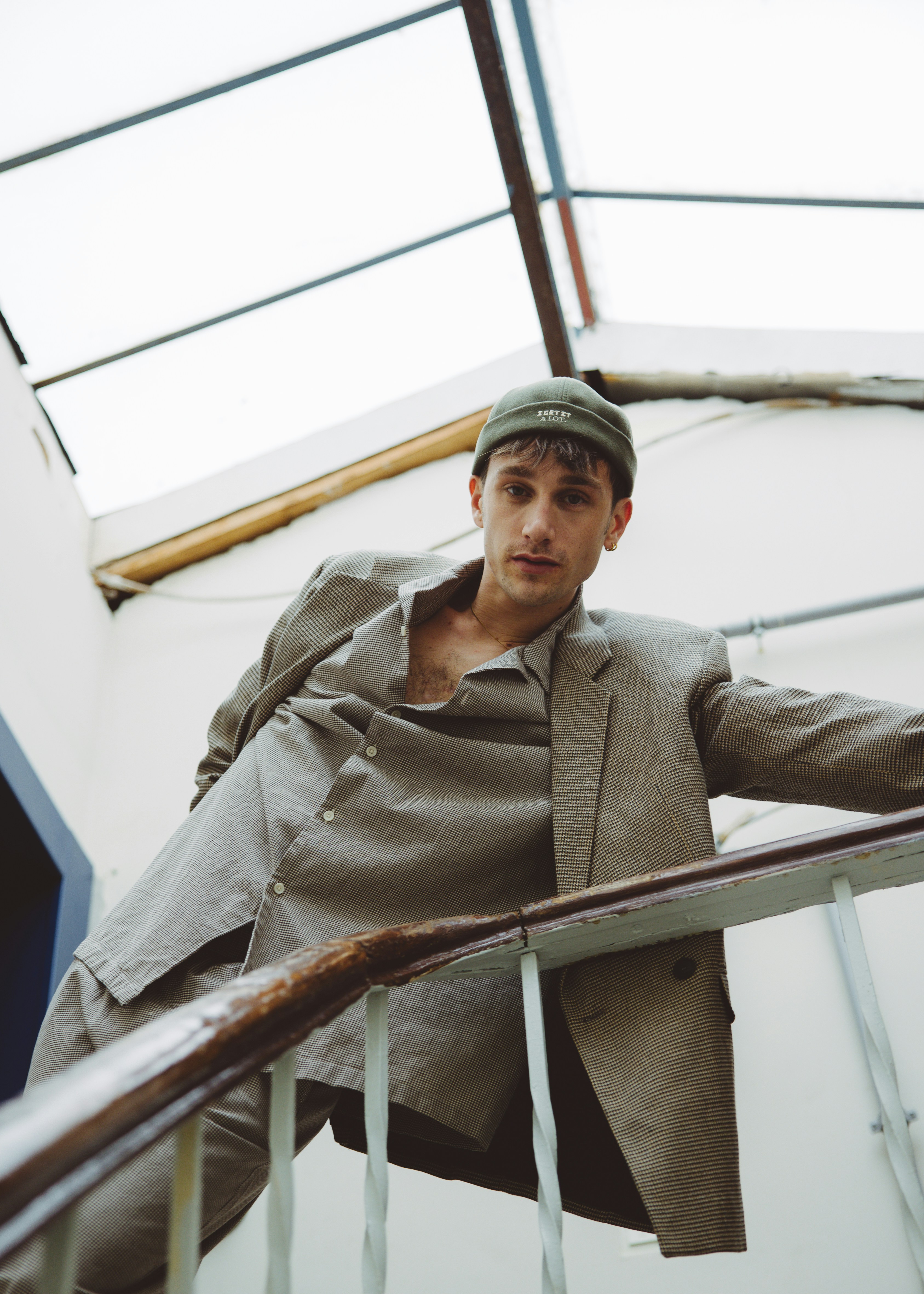 Man in hat by a railing