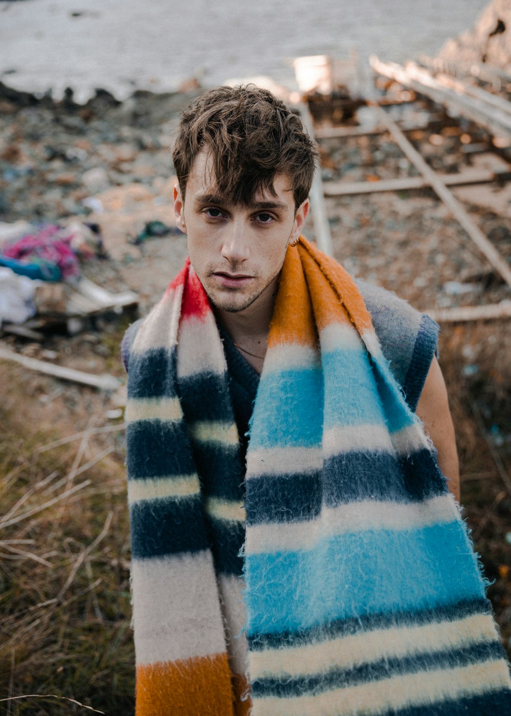 a man with a striped scarf around his neck