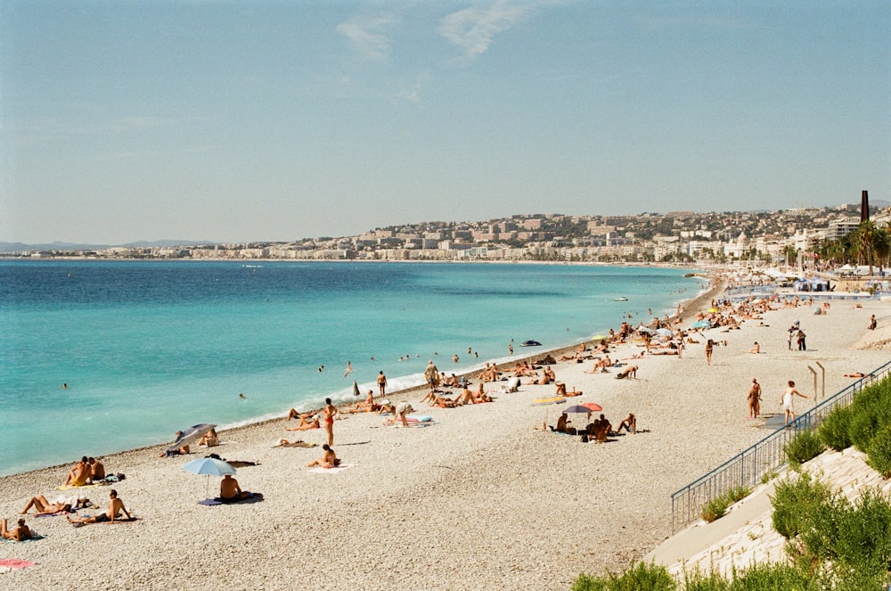 a crowded beach with many people on it