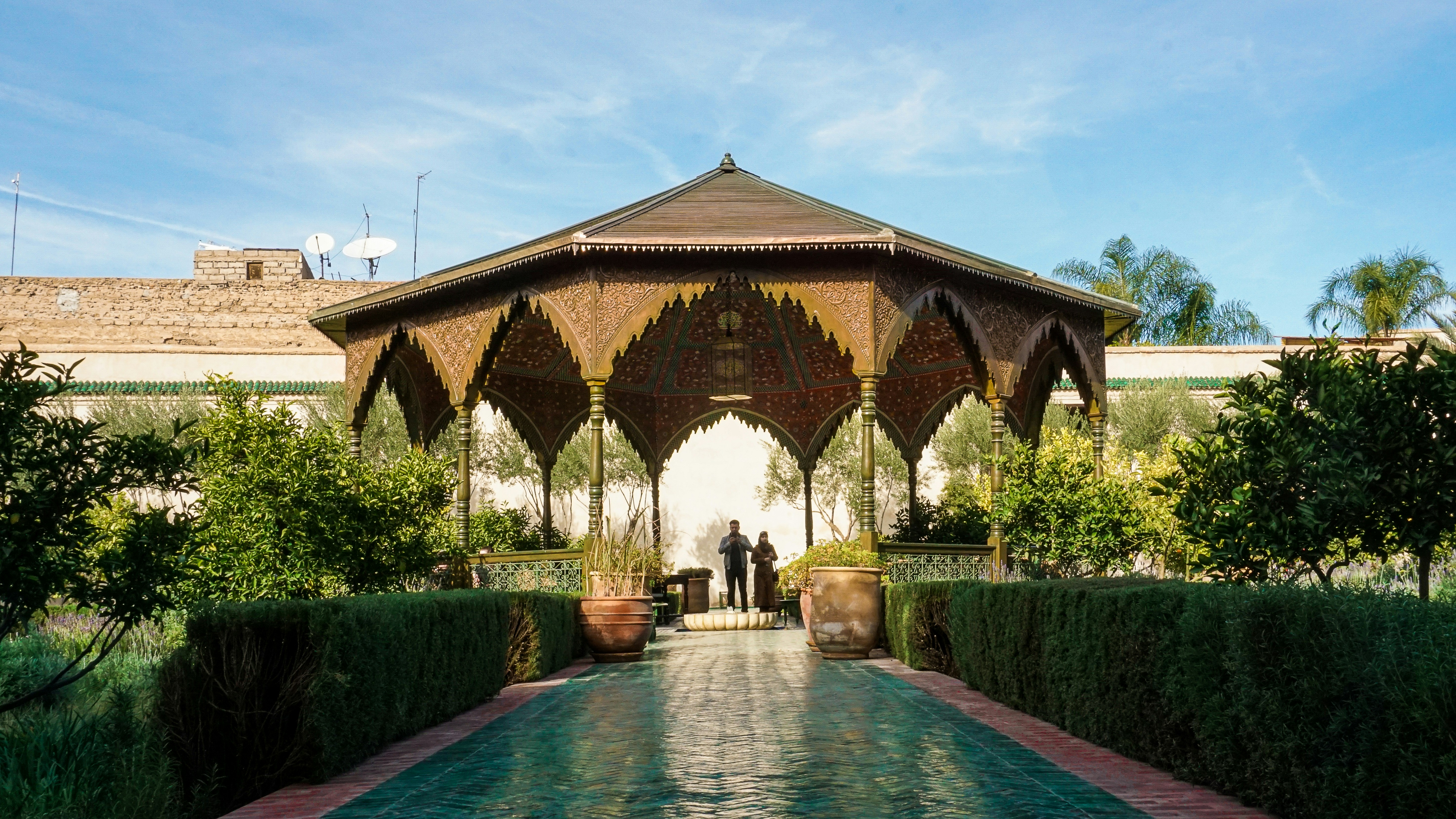 a gazebo with a couple standing in the middle of it, 