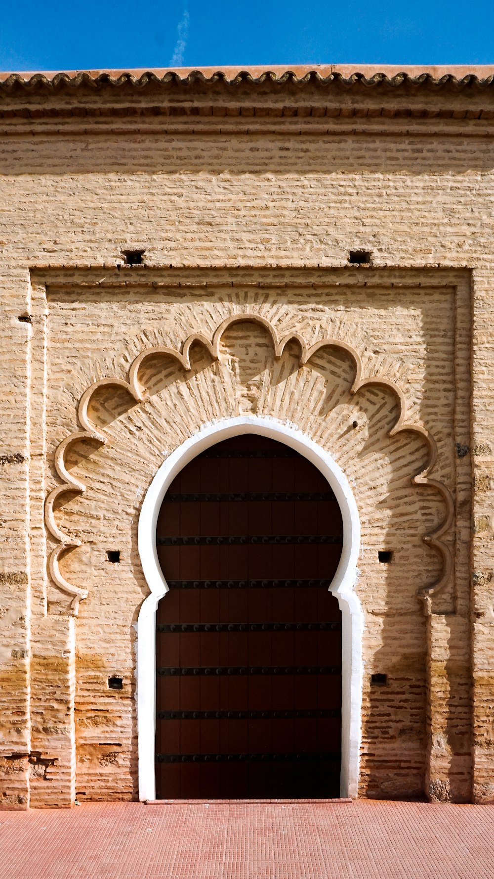 a large brick building with an arched doorway