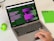 A laptop displaying a webpage about ChatGPT with a green and black design sits open on a desk. Next to the laptop is a small green Android figurine and a green notebook with 'ON' written on it. A hand is visible on the right side, interacting with the laptop's trackpad.