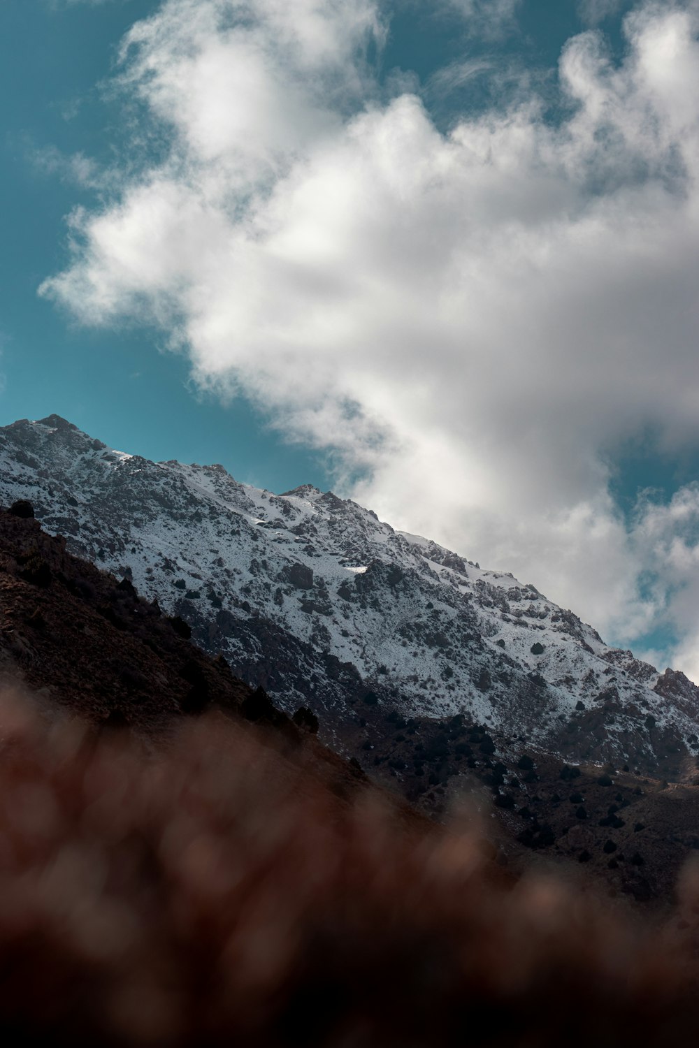 a view of a snow covered mountain from below