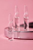 Close-up of peptide vials arranged neatly on a clean white surface with MW Wellness branding.