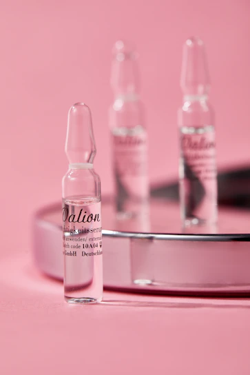 Close-up of clear peptide vials neatly arranged on a white surface with soft natural lighting.