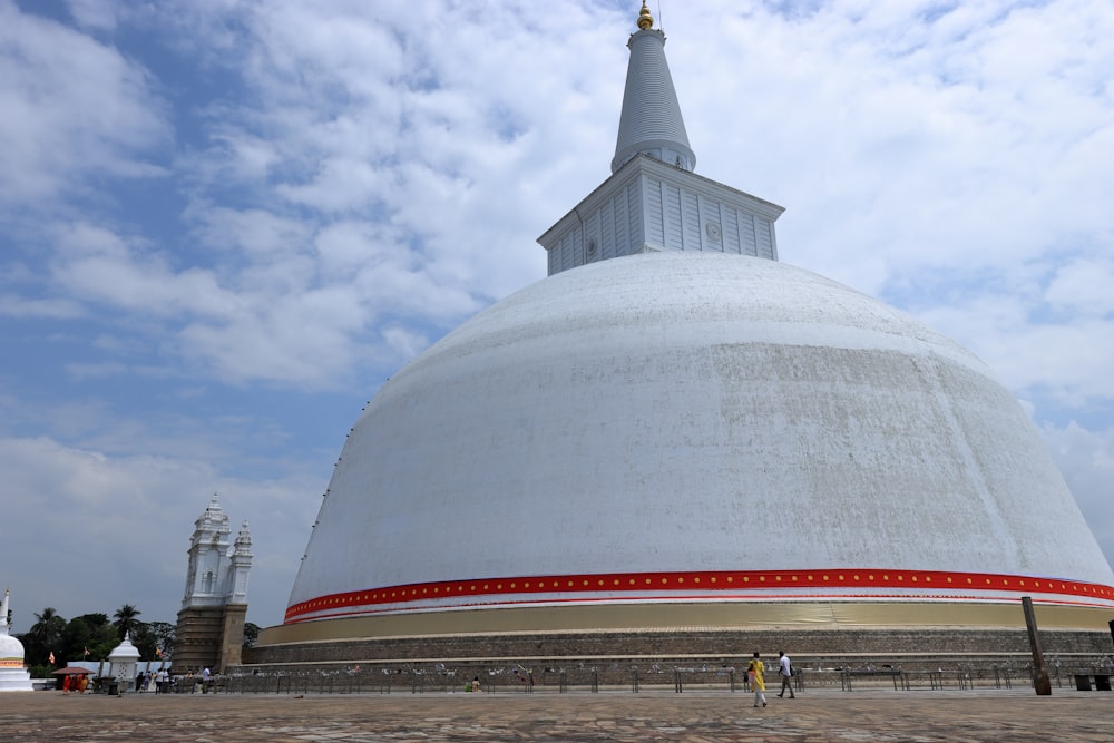 a large white building with a red stripe around it