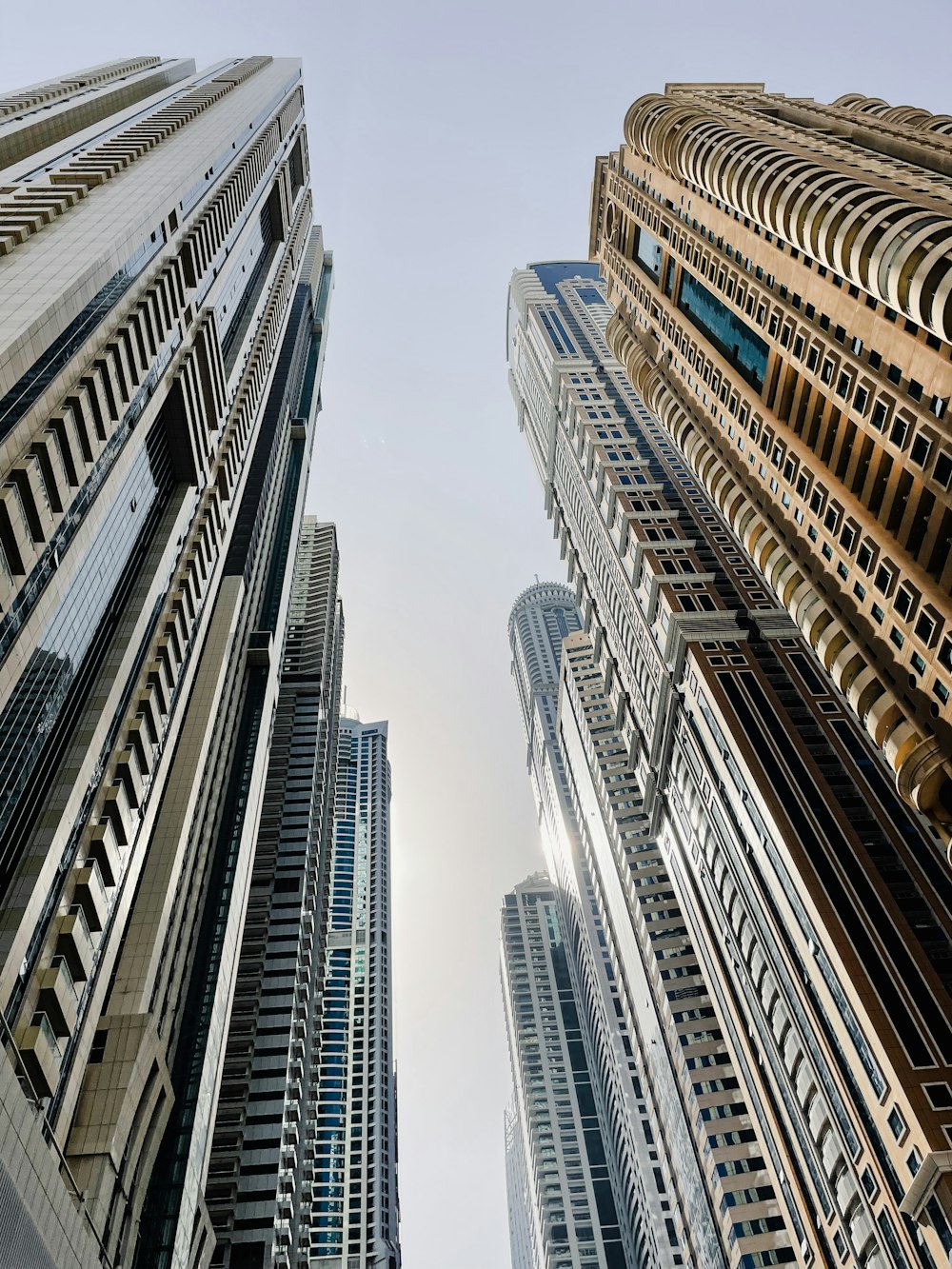 looking up at tall buildings in a city