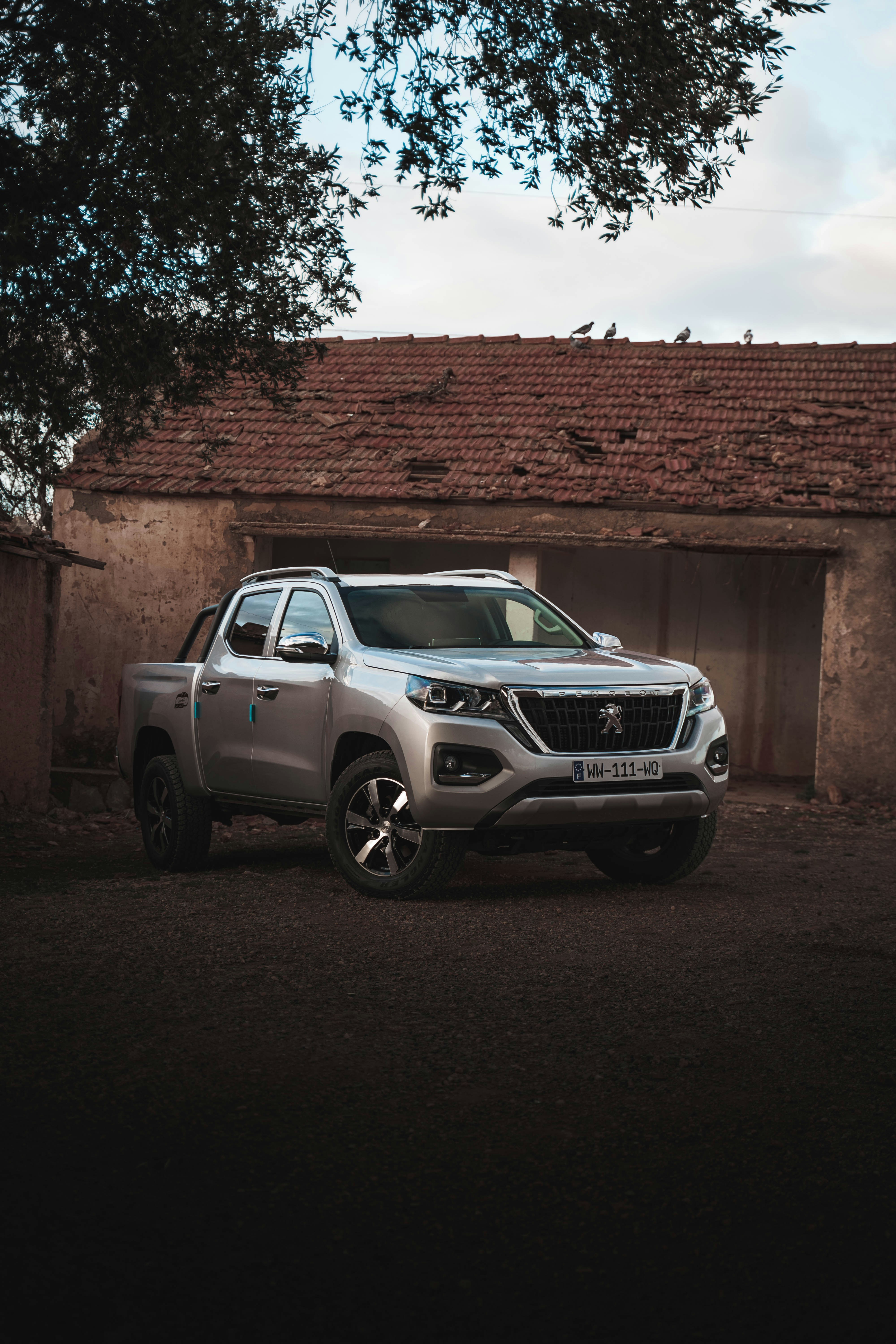 a silver truck parked in front of a building