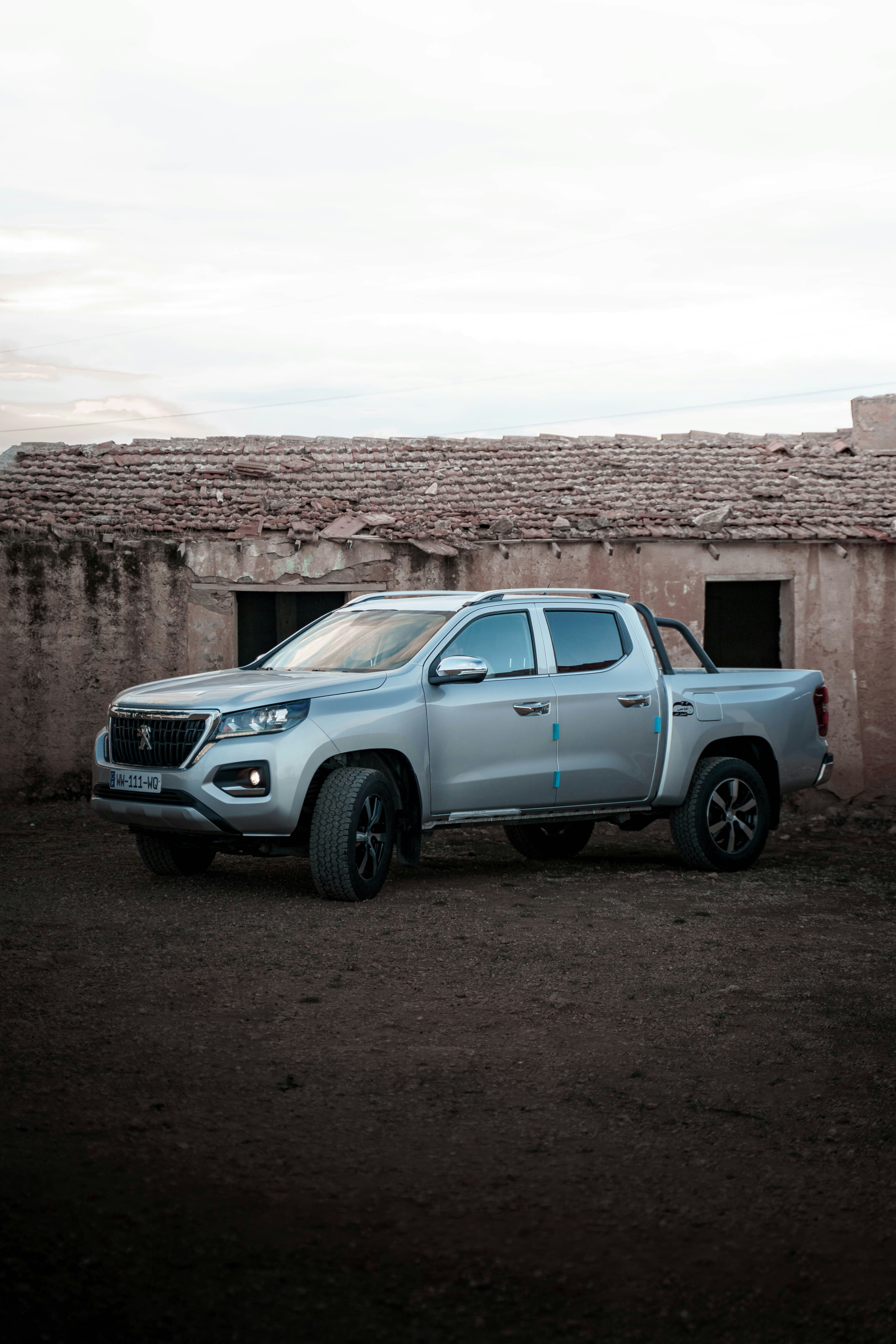 a silver truck parked in front of a building