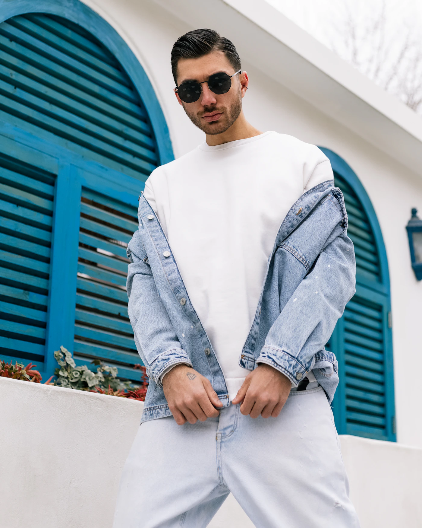 Model wearing a white T-shirt with a light denim jacket