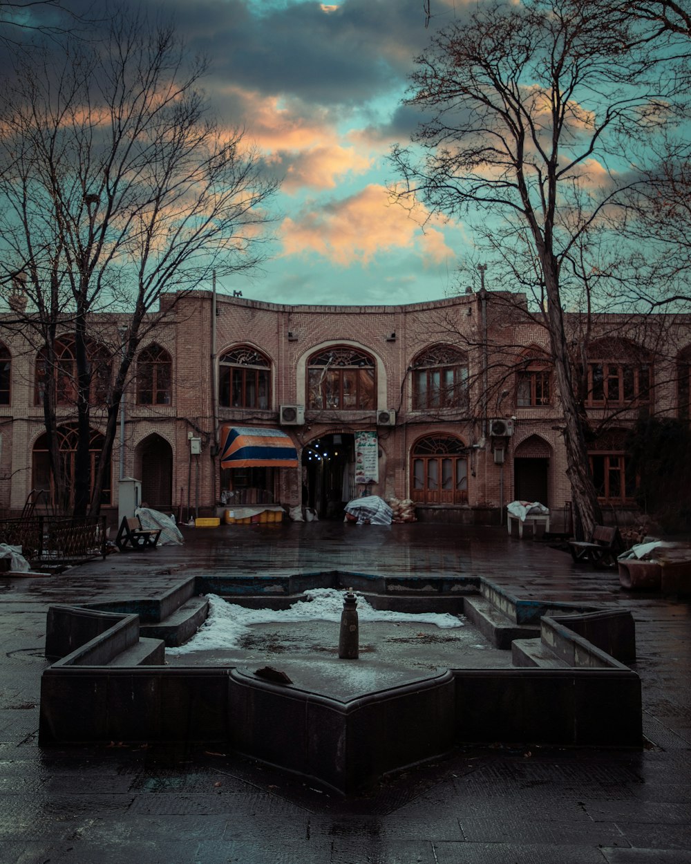 a large building with a fountain in front of it