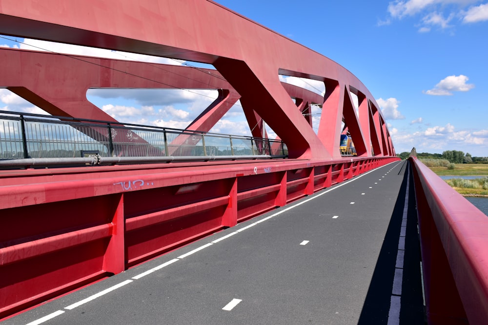 a red bridge over a body of water