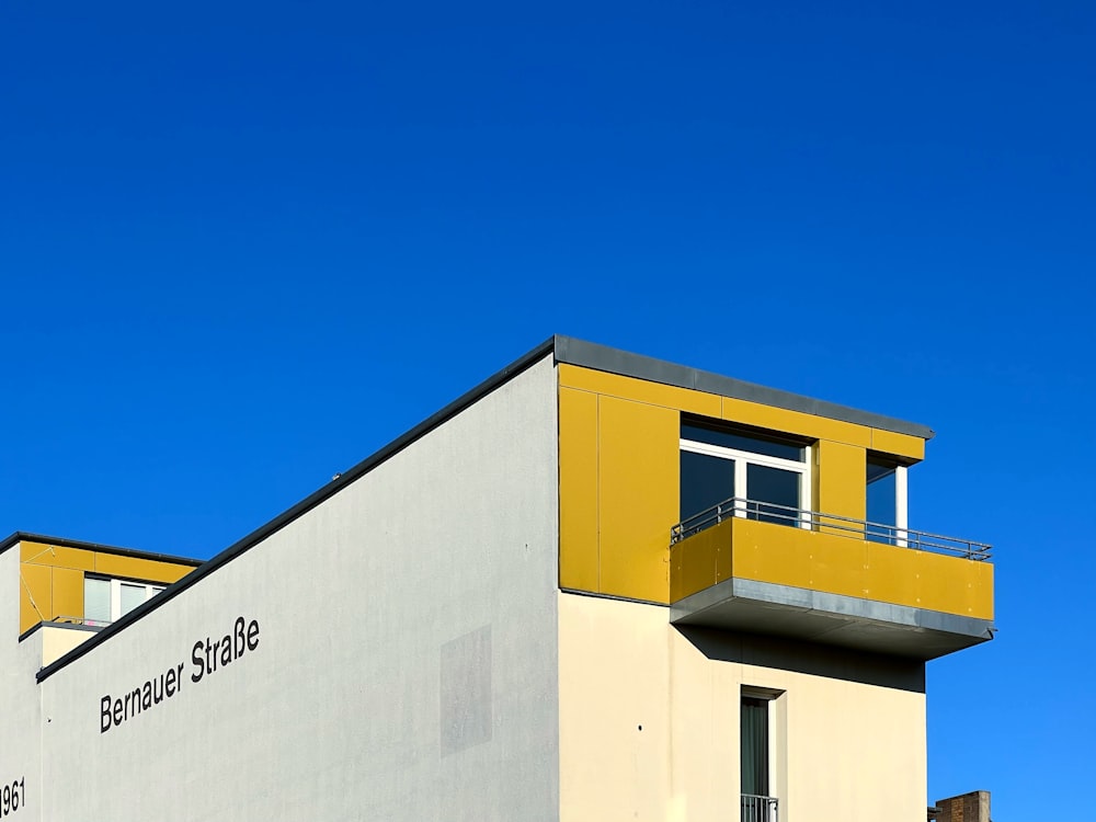 a yellow and white building with a balcony