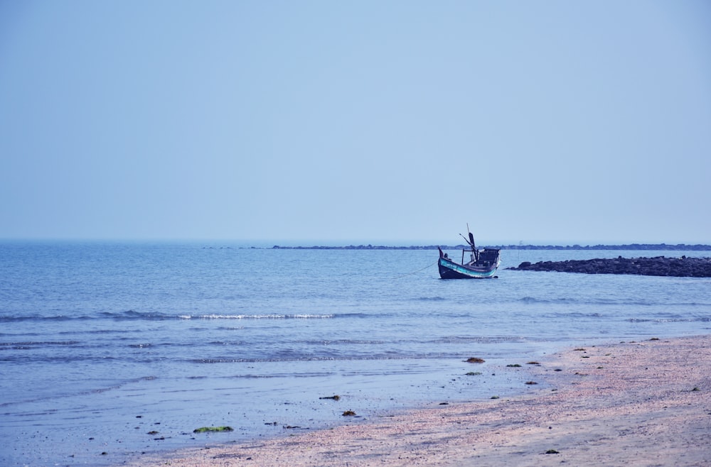 a small boat floating on top of a body of water