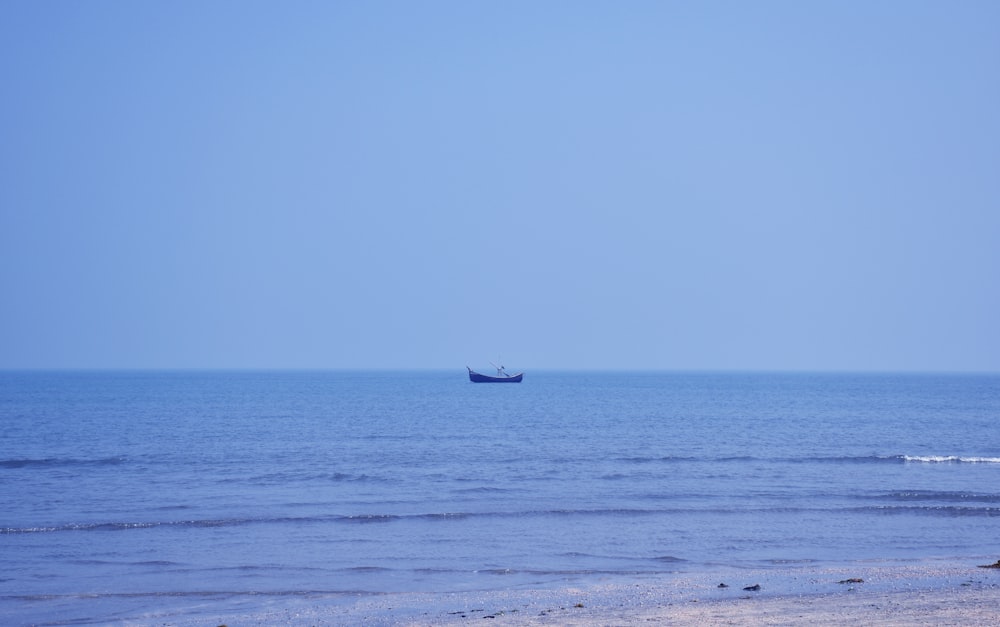 a boat is out in the ocean on a clear day