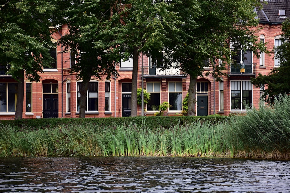 a red brick building next to a body of water