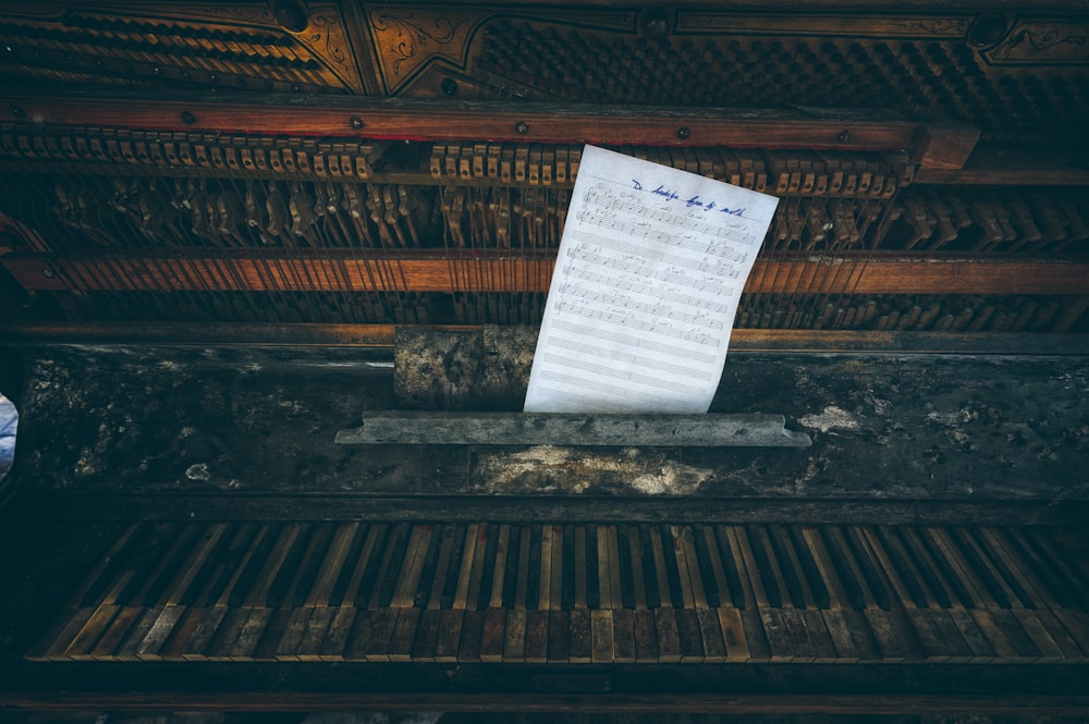 a sheet of paper sitting on top of a piano