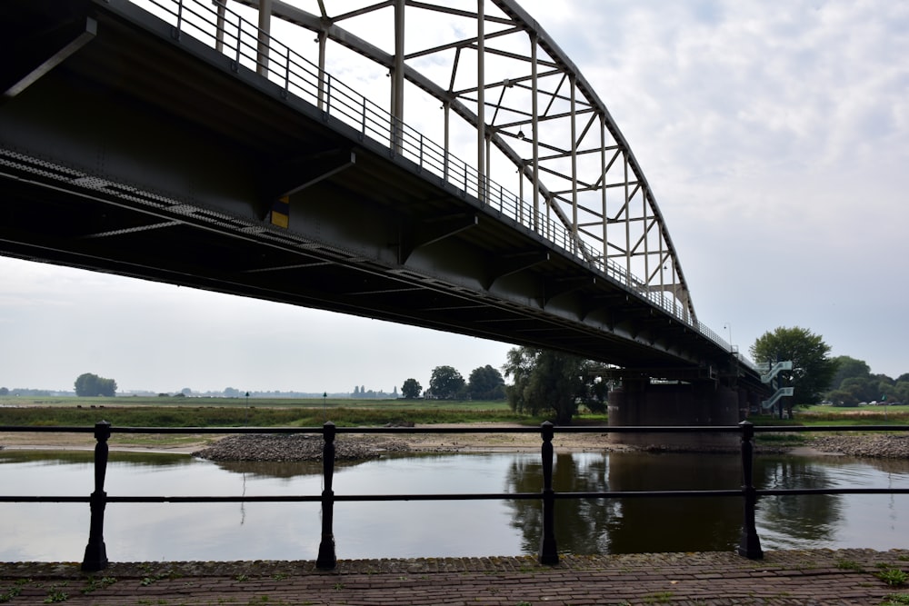 a bridge over a body of water on a cloudy day