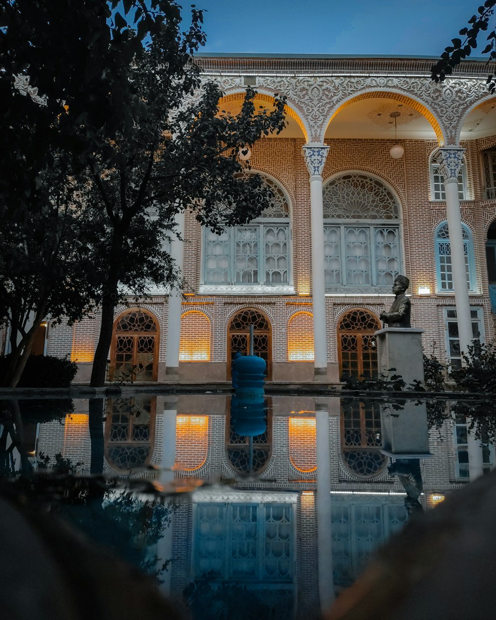 a large building with a pool in front of it