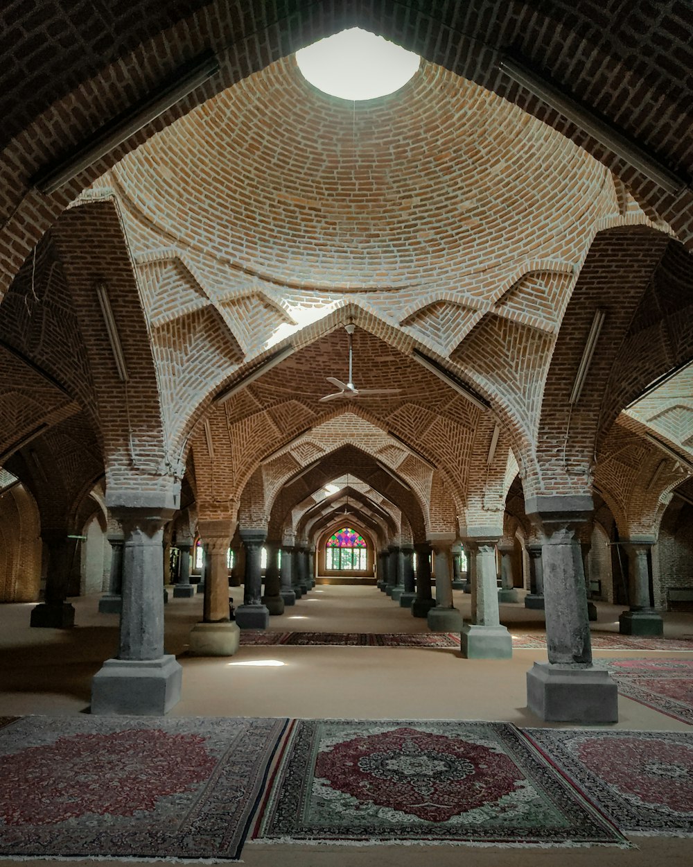 a large room with a ceiling and a rug on the floor