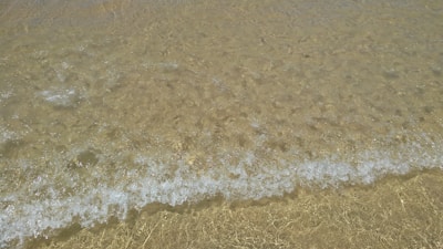 Gentle waves lapping a quiet shore at dawn, symbolizing breath’s rhythm.