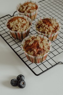 Baked healthy muffins with oats and berries, arranged neatly on a cooling rack.