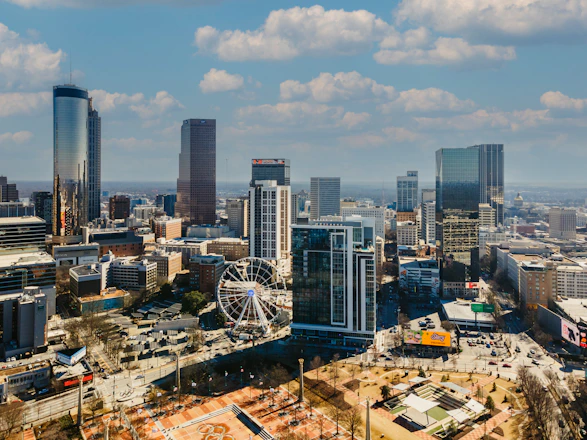 a view of a city with a ferris wheel in the foreground