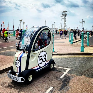 A compact car ready for a weekend getaway on a coastal road.