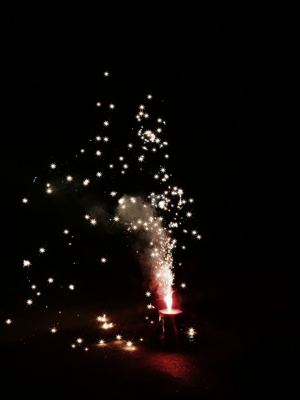 a large fireworks is lit up in the dark