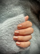 a woman's hand with a manicure on it