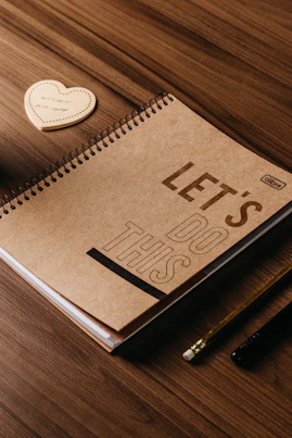 a notebook with the words let's less written on it