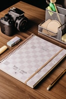 An organized desk featuring marketing materials and a planner.